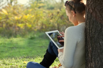 Woman Using iPad Outside