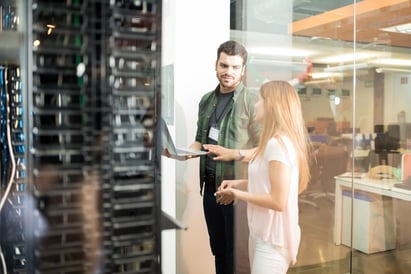 Man and Woman Talking in Server Room