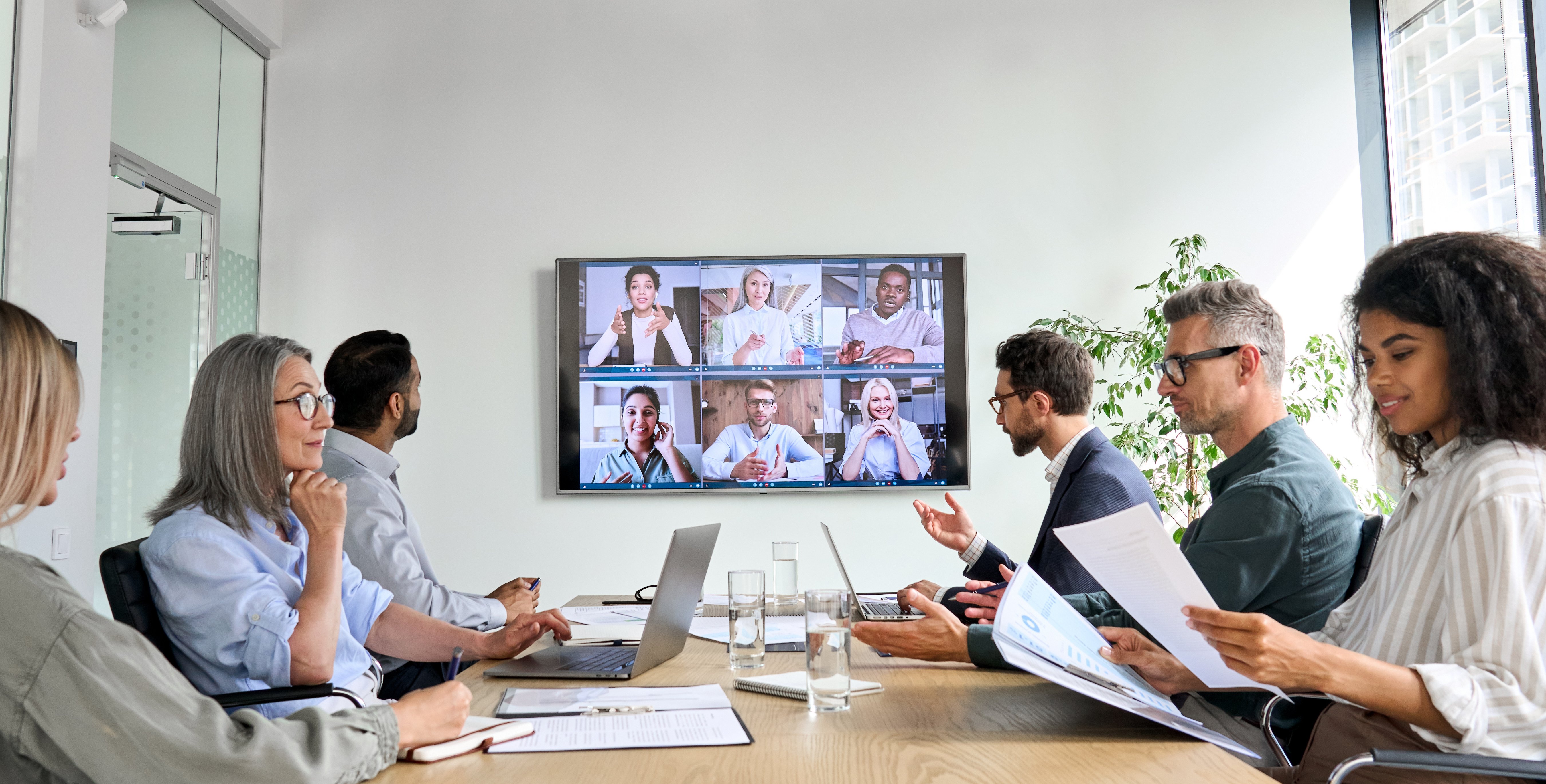 People in Conference Room with Video Conferencing