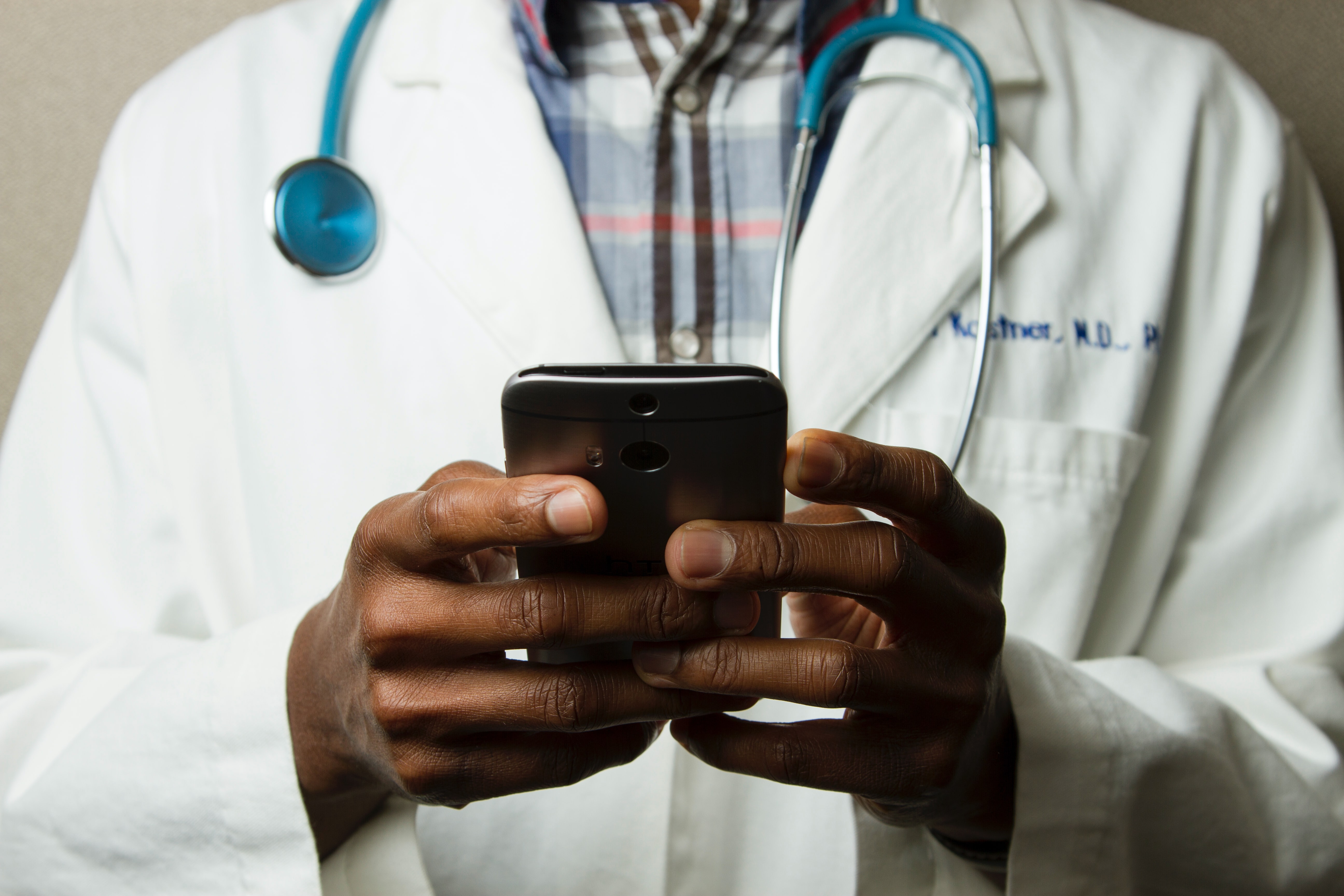 Healthcare worker holding a cellular device