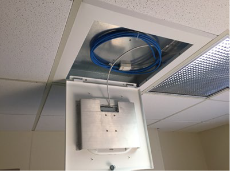 Oberon Model 1047 Locking suspended ceiling enclosure, shown with Meraki Wi-Fi AP in interchangeable door.