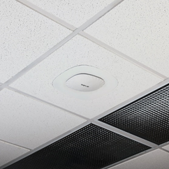 Oberon Model 1044 non-locking suspended ceiling and clouds ceiling mount, shown with Aruba Wi-Fi AP in interchangeable trim.